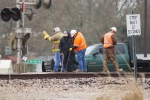 Track supervisor, track inspector and a couple of the VFD prying a crossing panel to clear the flangeway